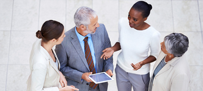 group-of-business-people_overhead-shot-in-office-chatting-ipad_413x185.png