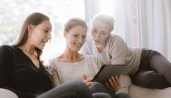 Mother and daughters sharing tablet